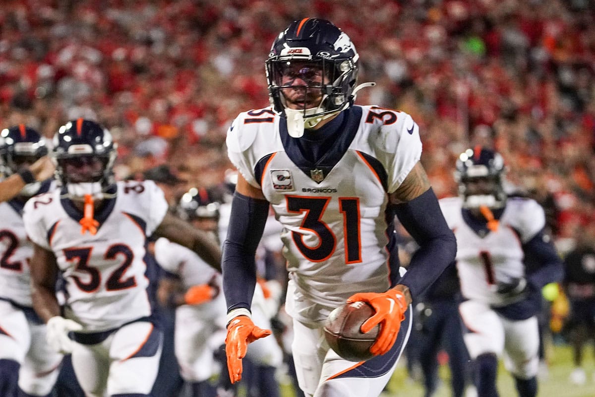  Denver Broncos safety Justin Simmons (31) celebrates after making an interception against the Kansas City Chiefs during the first half at GEHA Field at Arrowhead Stadium. 