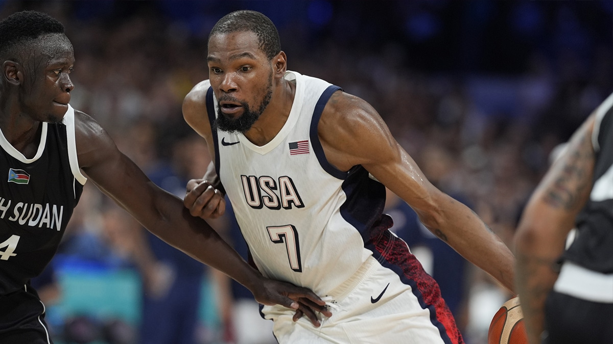 United States guard Kevin Durant (7) dribbles against South Sudan shooting guard Peter Jok (14) in the fourth quarter during the Paris 2024 Olympic Summer Games at Stade Pierre-Mauroy.