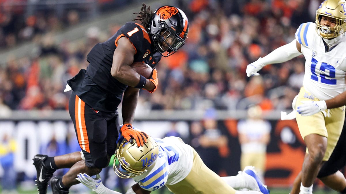 Oregon State Beavers running back Deshaun Fenwick (1) catches air as he is stopped by UCLA Bruins defensive back Kamari Ramsey (27) during the second half of the game