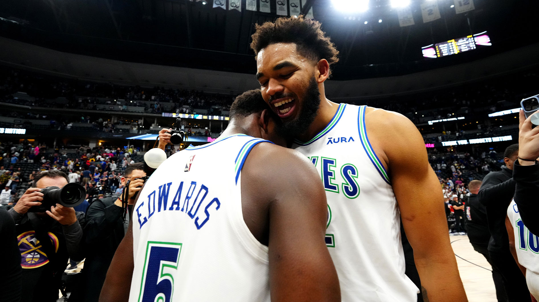 Minnesota Timberwolves center Karl-Anthony Towns (32) and Anthony Edwards (5) celebrate defeating the Denver Nuggets in game seven of the second round for the 2024 NBA playoffs at Ball Arena.