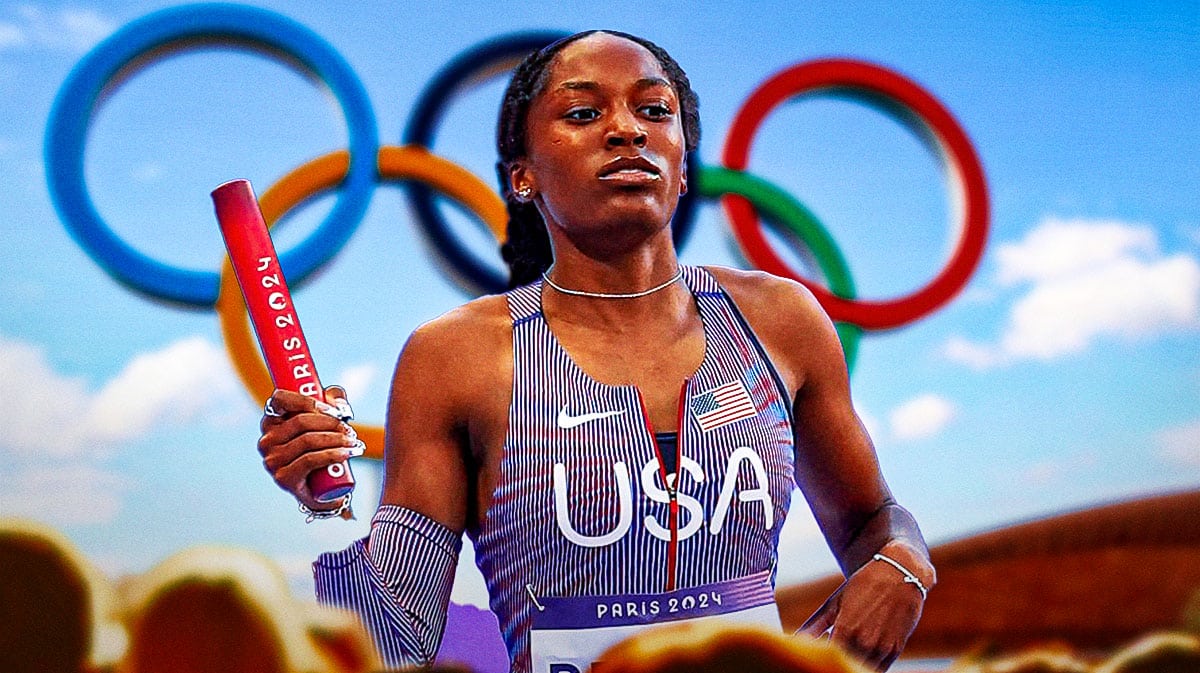 Kaylyn Brown running with Olympic rings behind her