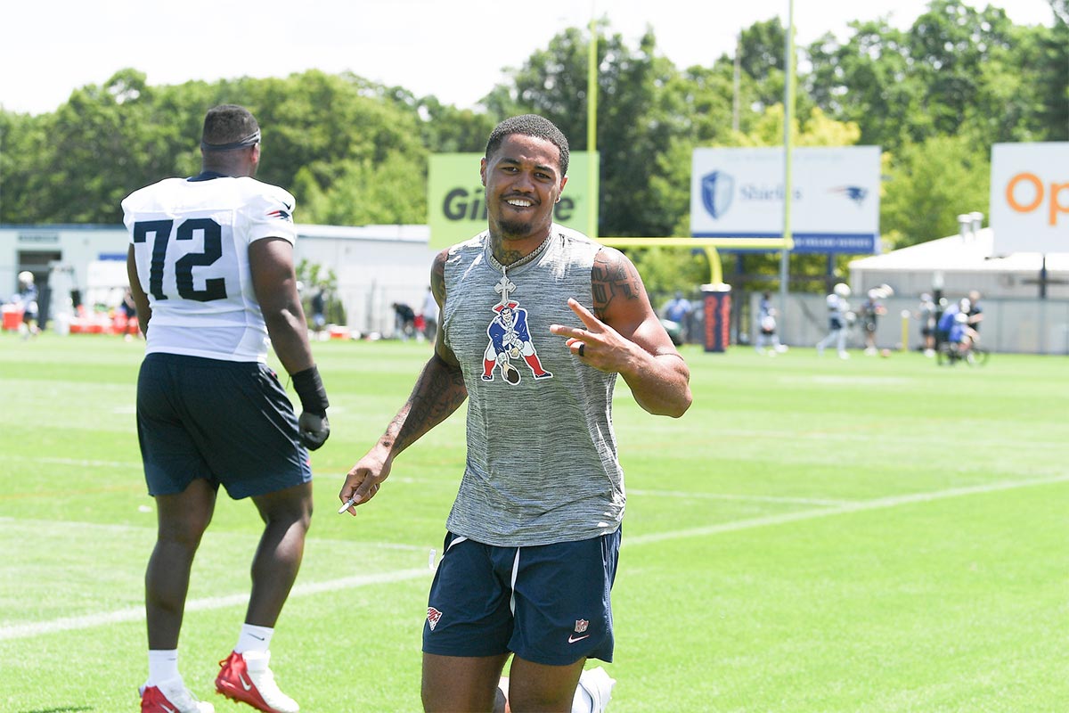 New England Patriots wide receiver Kendrick Bourne (84) stops for a photo while signing autographs for fans during training camp at Gillette Stadium.