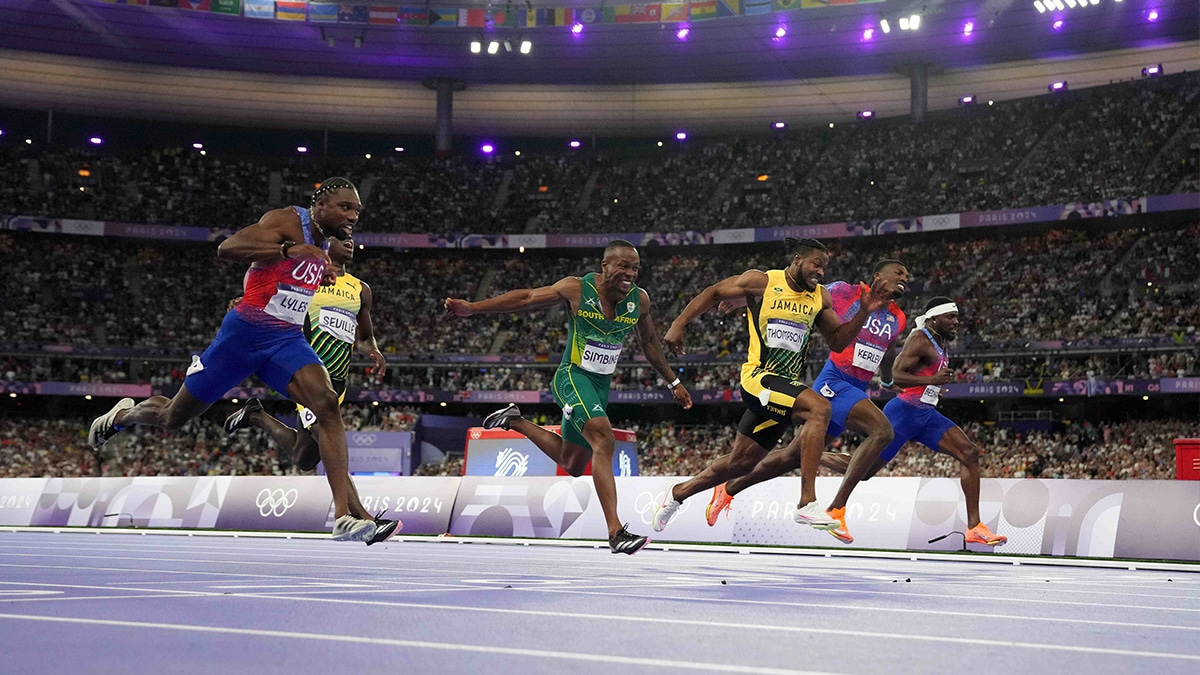 Aug 4, 2024; Paris Saint-Denis, France; Noah Lyles (USA) defeats Kishane Thompson (JAM) to win the 100m with both runners timed in 9.79 during the Paris 2024 Olympic Summer Games at Stade de France. From left: Lyles, Oblique Seville (JAM), Akani Simbine (RSA), Thompson, Fred Kerley (USA) and Kenny Bednarek (USA). Mandatory Credit: Kirby Lee-USA TODAY Sports