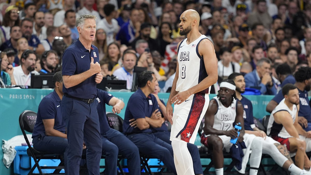United States head coach Steve Kerr talks to United States guard Derrick White (8) in the first quarter against South Sudan during the Paris 2024 Olympic Summer Games at Stade Pierre-Mauroy.