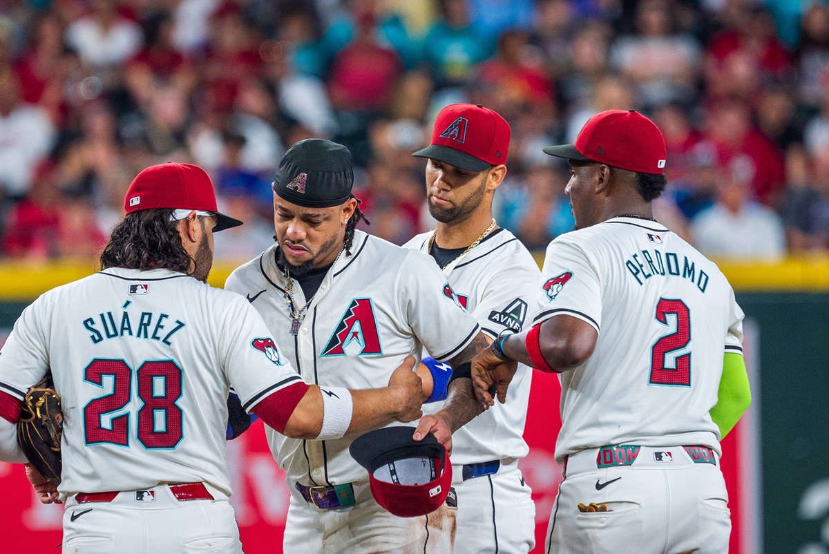 Arizona Diamondbacks infielder Ketel Marte (4) reacts after a collision with Philadelphia Phillies catcher Garrett Stubbs (21) (not shown) at second base in the fourth inning during a game against the Philadelphia Phillies at Chase Field. 