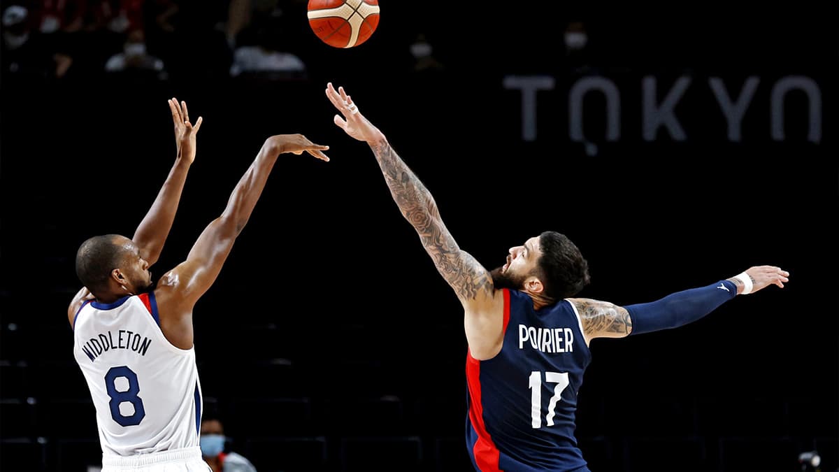 United States small forward Khris Middleton (8) shoots the ball against France centre Vincent Poirier (17) in the men's basketball gold medal game during the Tokyo 2020 Olympic Summer Games at Saitama Super Arena.