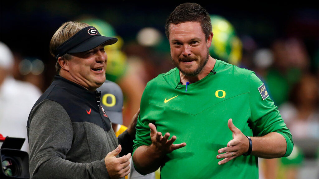 Georgia head coach Kirby Smart and Oregon head coach Dan Lanning meet during warm ups before the start of the Chick-fil-A Kickoff NCAA college football game between Oregon and Georgia in Atlanta, on Saturday, Sept. 3, 2022. 