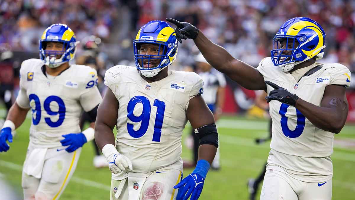Los Angeles Rams defensive tackle Kobie Turner (91) with linebacker Byron Young (0) and defensive tackle Aaron Donald (99) against the Arizona Cardinals at State Farm Stadium.