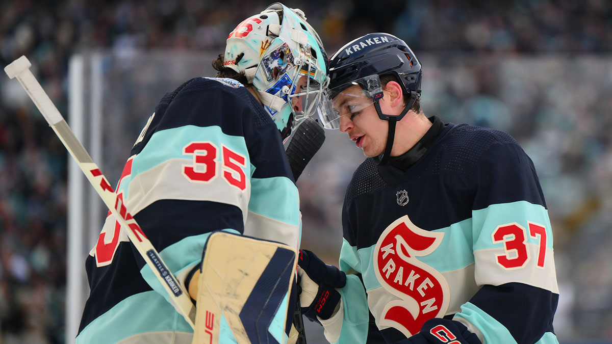Seattle Kraken goaltender Joey Daccord (35) and center Yanni Gourde (37) celebrate after defeating the Vegas Golden Knights in the 2024 Winter Classic ice hockey game at T-Mobile Park.
