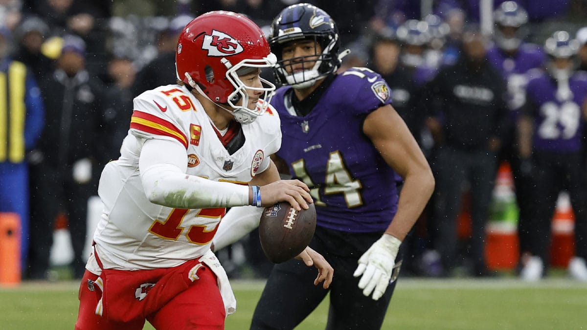 Kansas City Chiefs quarterback Patrick Mahomes (15) scrambles from Baltimore Ravens safety Kyle Hamilton (14) in the AFC Championship football game at M&T Bank Stadium. 