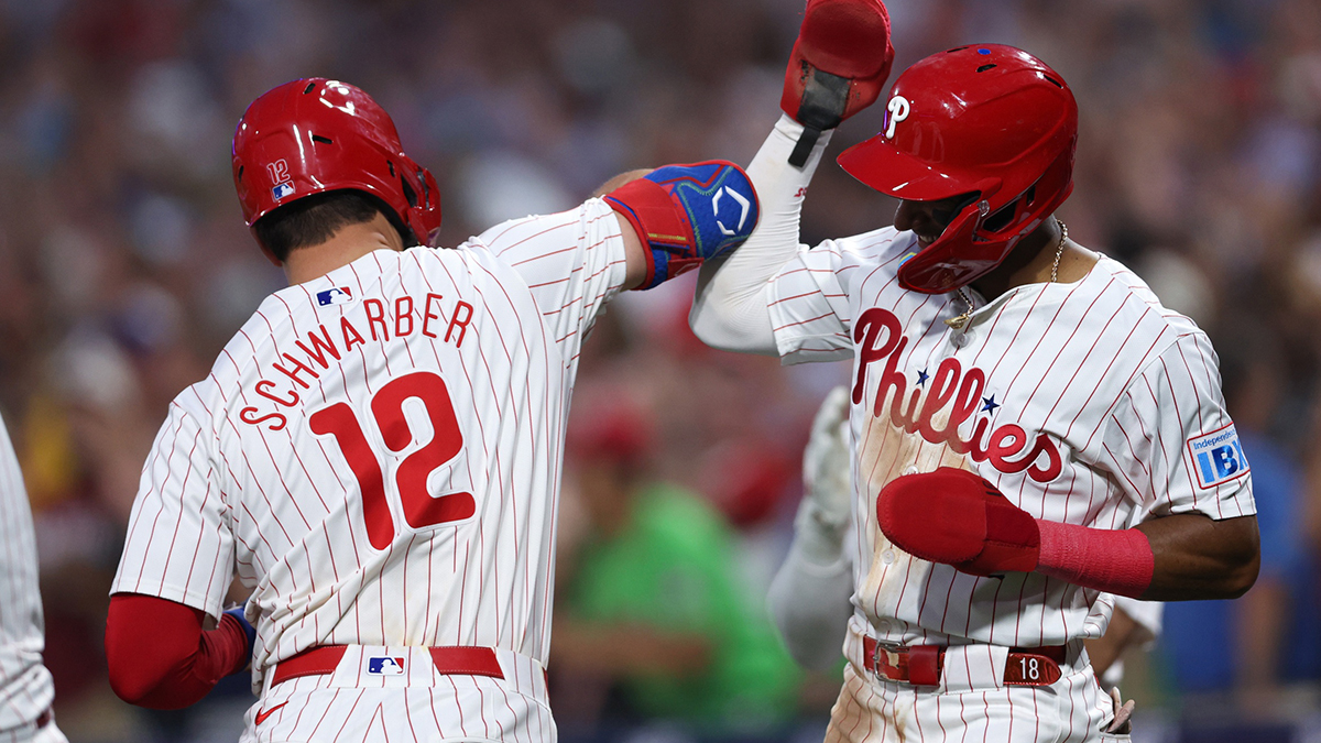 Aug 14, 2024; Philadelphia, Pennsylvania, USA; Philadelphia Phillies designated hitter Kyle Schwarber (12) celebrates with outfielder Johan Rojas (18) after hitting a four RBI grand slam during the fourth inning against the Miami Marlins at Citizens Bank Park. Mandatory Credit: Bill Streicher-USA TODAY Sports