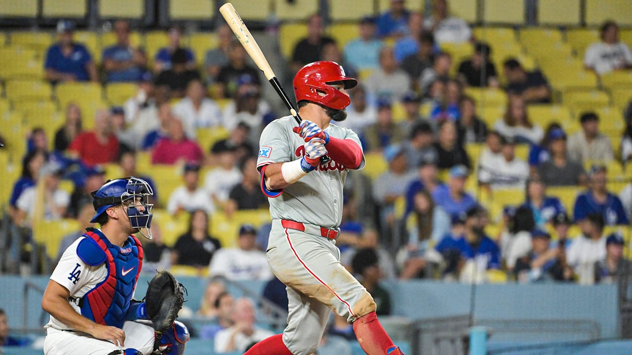 Philadelphia Phillies designated hitter Kyle Schwarber (12) hits a solo home run, his third of the game, in the eighth inning against the Los Angeles Dodgers at Dodger Stadium.