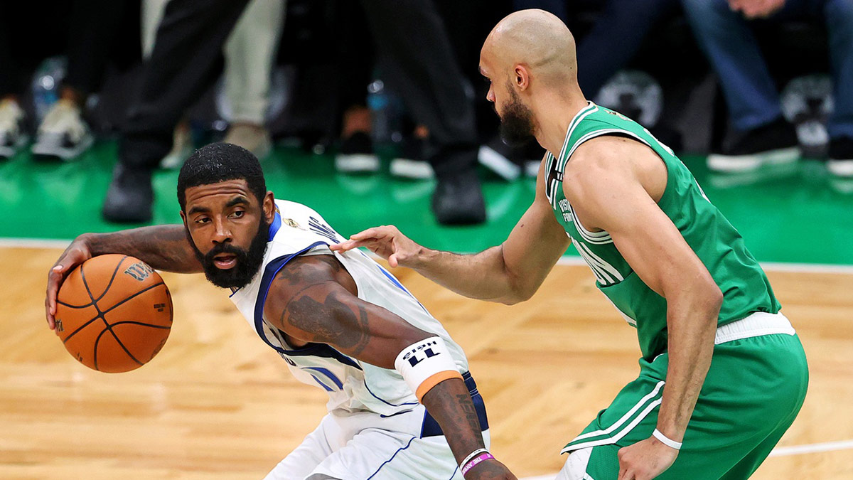 Dallas Mavericks guard Kyrie Irving (11) handles the ball against Boston Celtics guard Derrick White (9) in game five of the 2024 NBA Finals at TD Garden.