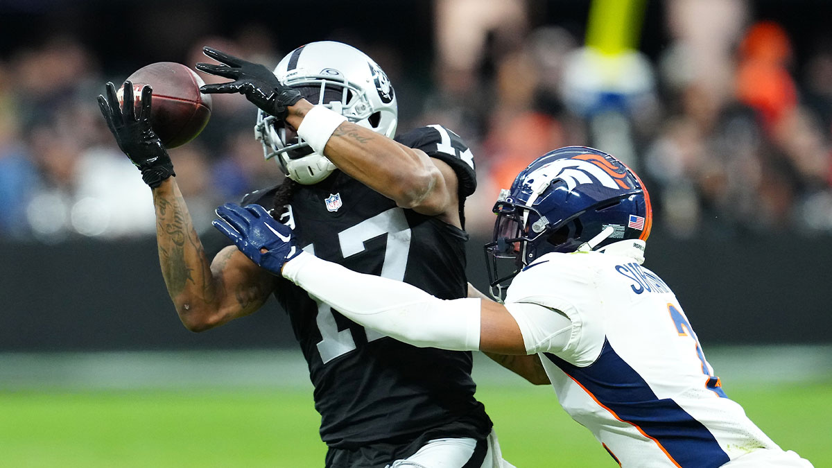 Las Vegas Raiders wide receiver Davante Adams (17) makes a catch against Denver Broncos cornerback Pat Surtain II (2) during the second quarter at Allegiant Stadium. 