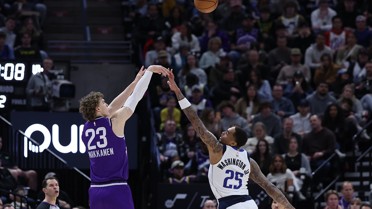 Utah Jazz forward Lauri Markkanen (23) shoots a three point shot against Dallas Mavericks forward P.J. Washington (25) during the second quarter at Delta Center. 