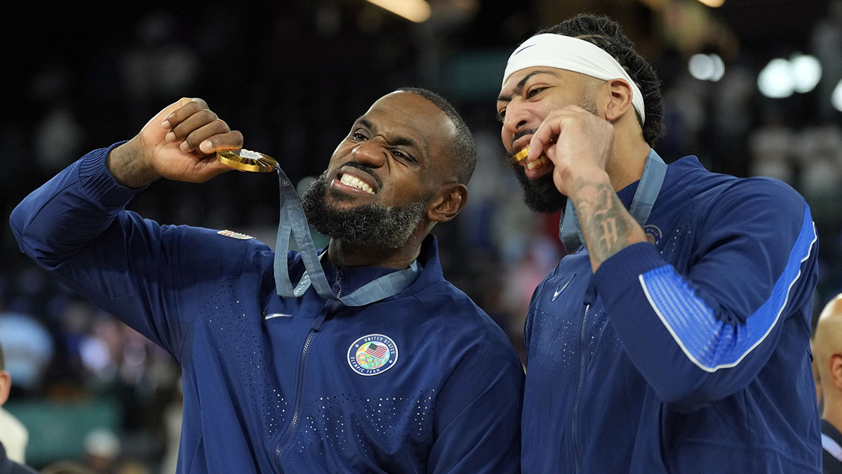 United States guard LeBron James (6) and centre Anthony Davis (14) celebrate after defeating France in the men's basketball gold medal game during the Paris 2024 Olympic Summer Games at Accor Arena.