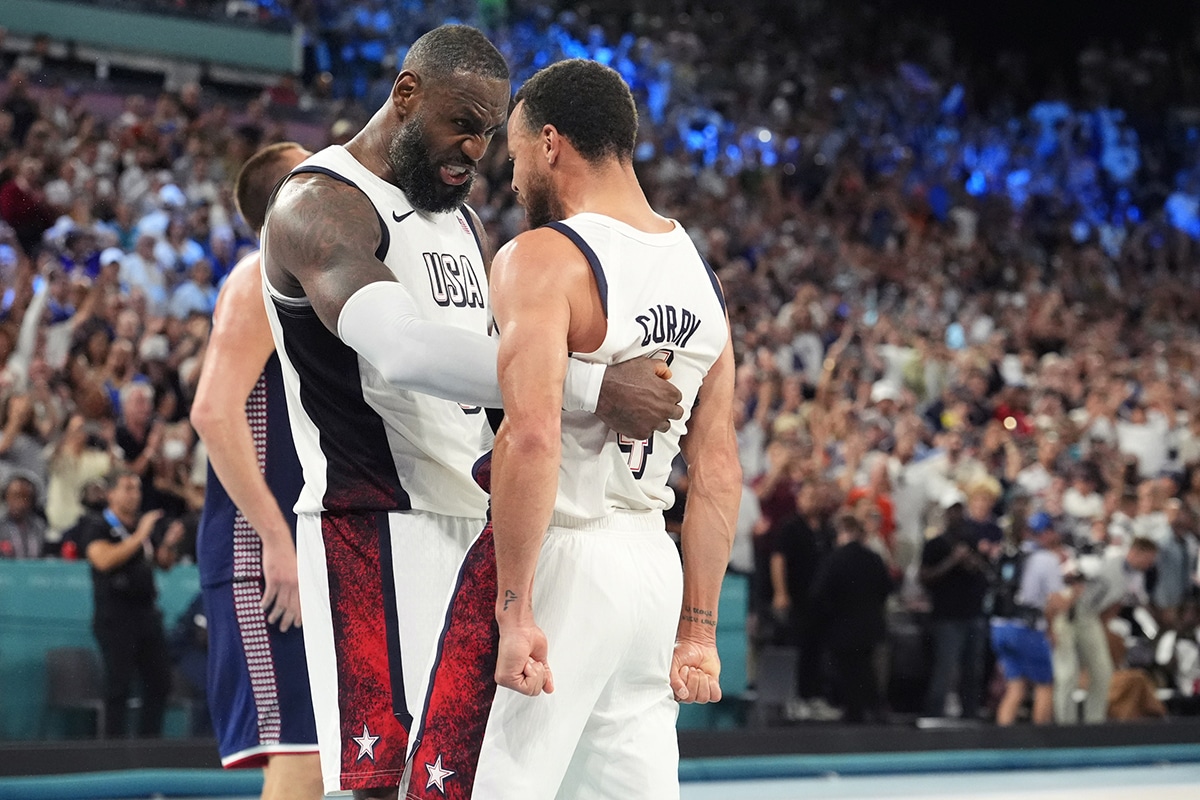 United States guard LeBron James (6) and shooting guard Stephen Curry (4) celebrate after the game against Serbia in a men's basketball semifinal game during the Paris 2024 Olympic Summer Games at Accor Arena.