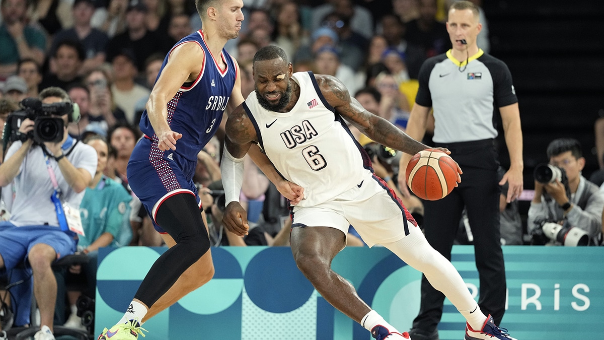 United States guard LeBron James (6) drives to the basket while defended by Serbia centre Filip Petrusev (3) during the first half in a men's basketball semifinal game during the Paris 2024 Olympic Summer Games at Accor Arena. 