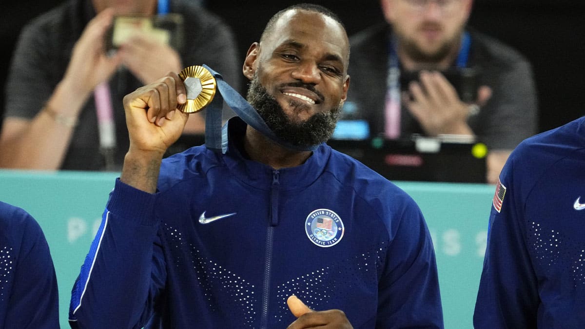 United States guard LeBron James (6) celebrates with the gold medal after defeating France in the men's basketball gold medal game during the Paris 2024 Olympic Summer Games at Accor Arena.