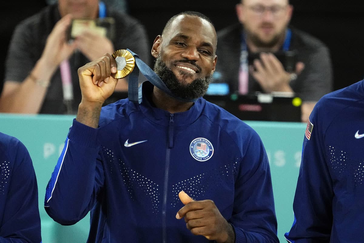 United States guard LeBron James (6) celebrates with the gold medal after defeating France in the men's basketball gold medal game during the Paris 2024 Olympic Summer Games at Accor Arena.