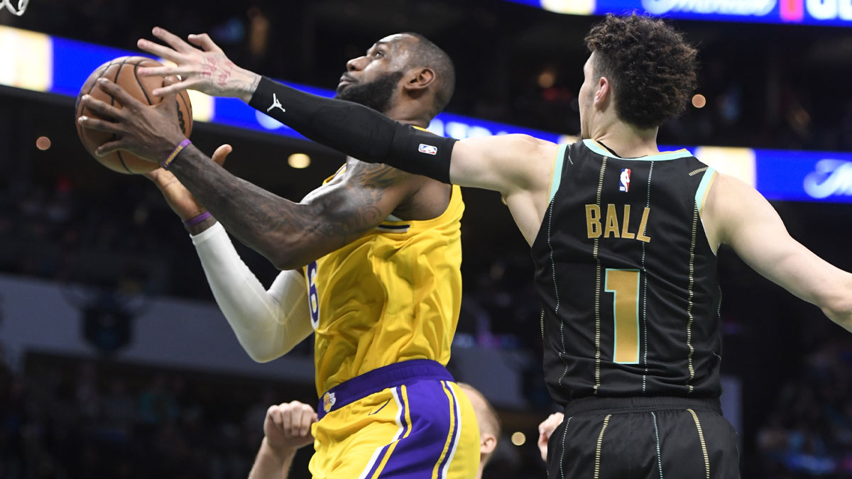  Los Angeles Lakers forward LeBron James (6) drives in as he is defended by Charlotte Hornets guard LaMelo Ball (1) during second half at the Spectrum Center.