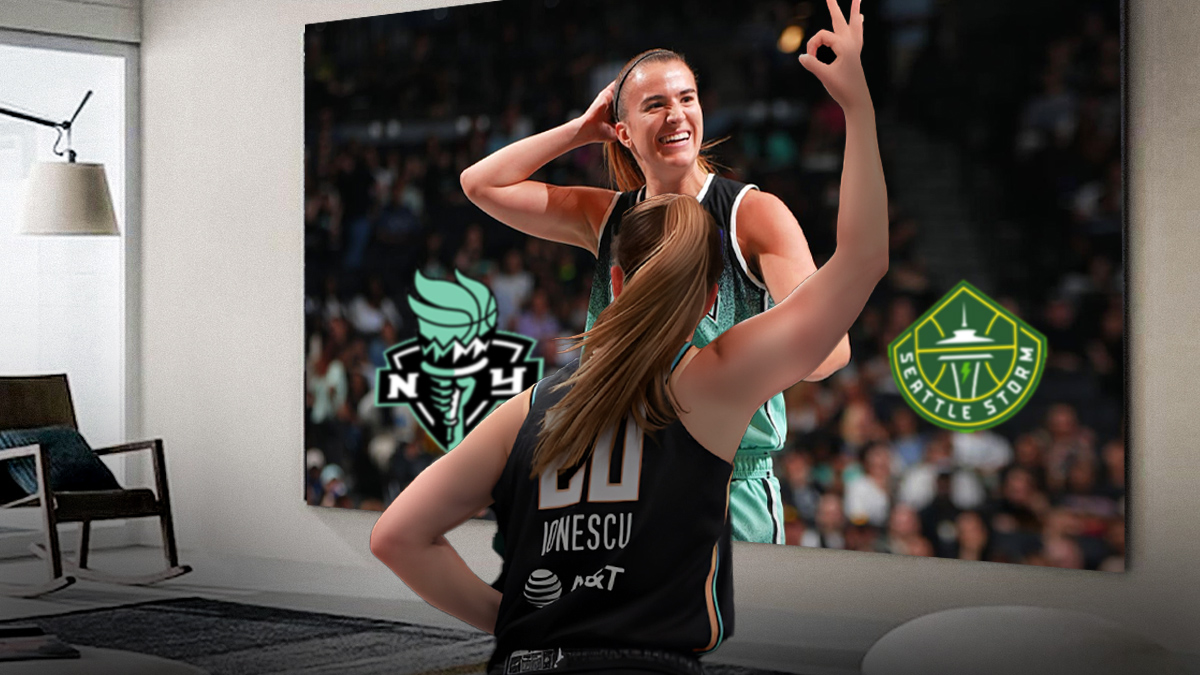 Liberty guard Sabrina lonescu watching a clip of herself on the tv smiling with the Liberty logo next to the Storm's logo