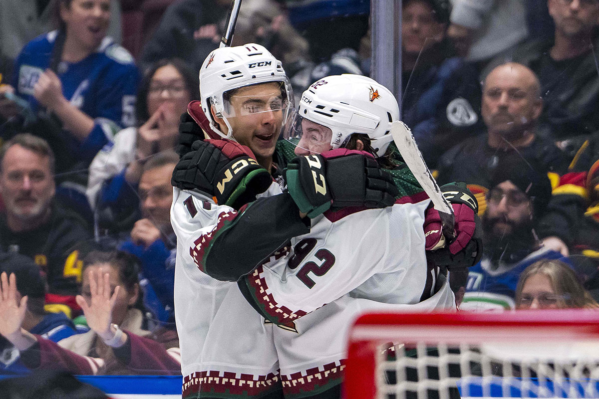  Arizona Coyotes forward Dylan Guenther (11) and forward Logan Cooley (92) celebrate Cooley’s game winning overtime goal against the Vancouver Canucks at Rogers Arena. Arizona won 4-3 in overtime