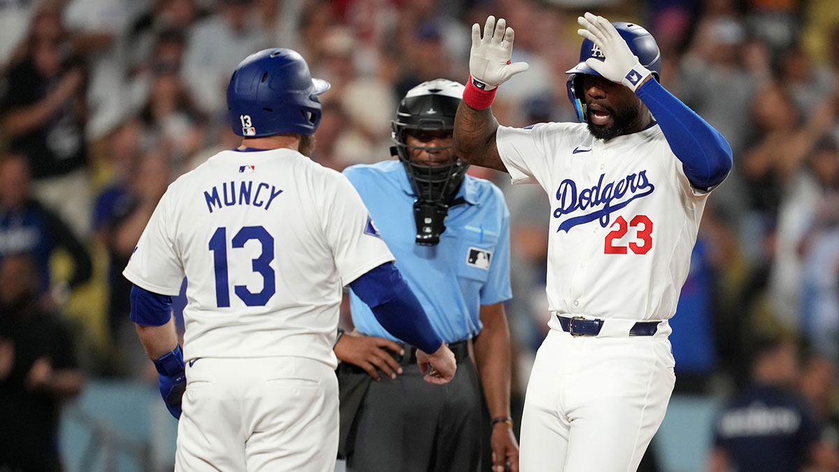 Los Angeles Dodgers right fielder Jason Heyward (23) celebrates with third baseman Max Muncy (13) after hitting a three-run home run in the eighth inning against the Seattle Mariners at Dodger Stadium.