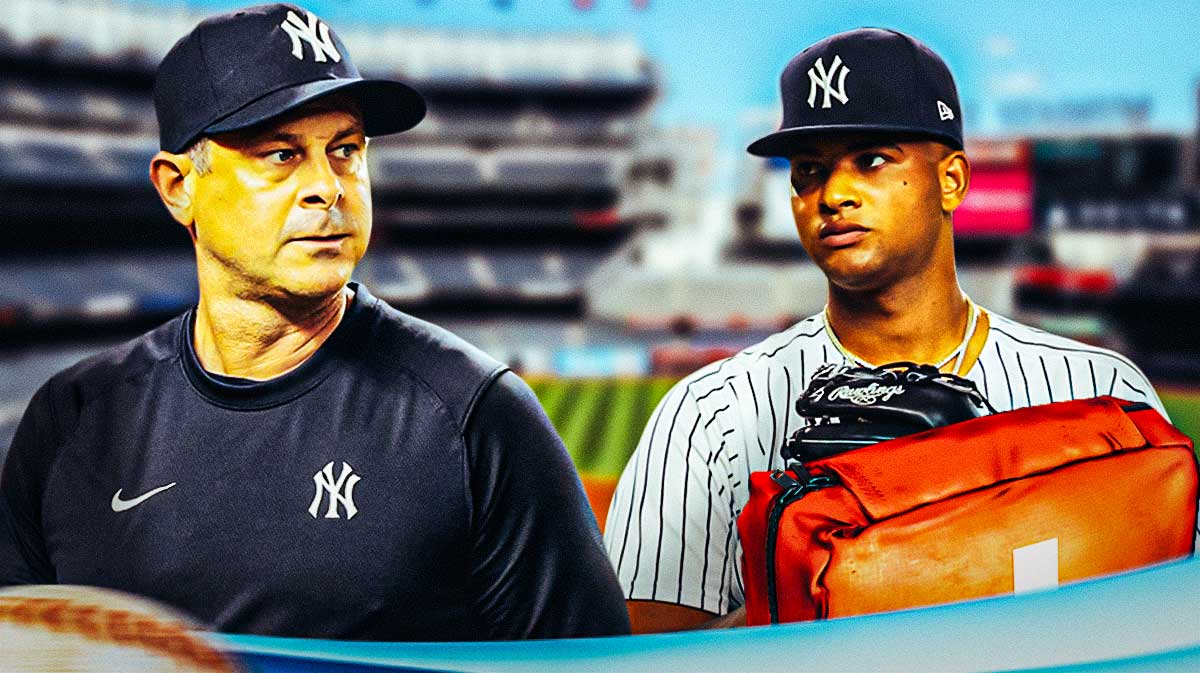 Luis Gil with a first aid kit near him with Aaron Boone as Gil landed on the injured list with a back injury. the Yankees injuries to the rotation pile up.