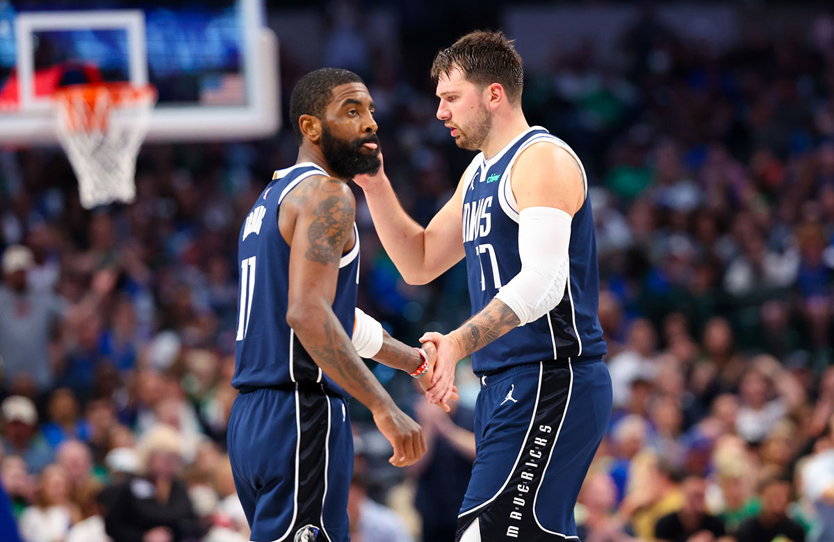Dallas Mavericks guard Kyrie Irving (11) celebrates with Dallas Mavericks guard Luka Doncic (77) during the second half against the Denver Nuggets at American Airlines Center.