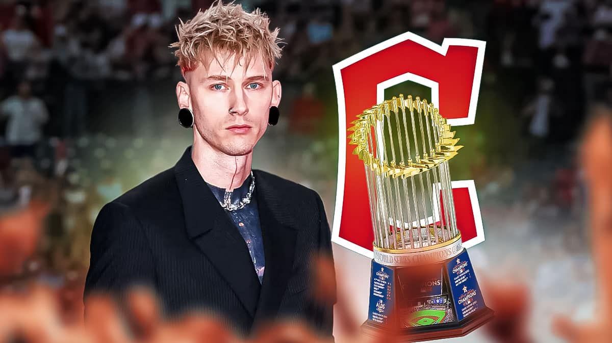 Machine Gun Kelly and the World Series trophy in front of Cleveland Guardians logo