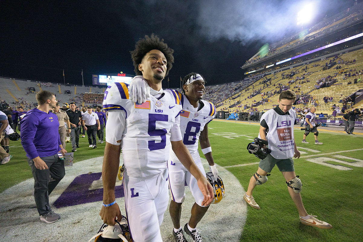 LSU Tigers quarterback Jayden Daniels (5) and wide receiver Malik Nabers (8) walk off the field after defeating the Army Black Knights at Tiger Stadium. 