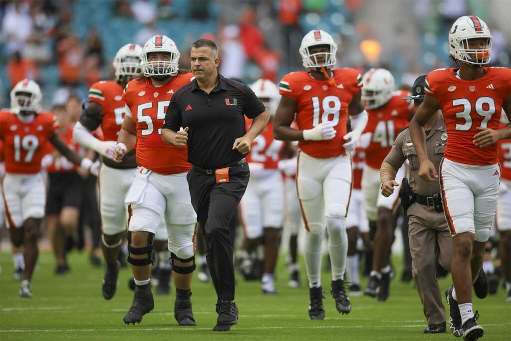 Miami Hurricanes head coach Mario Cristobal takes on the field prior to the game against the Virginia Cavaliers at Hard Rock Stadium. 