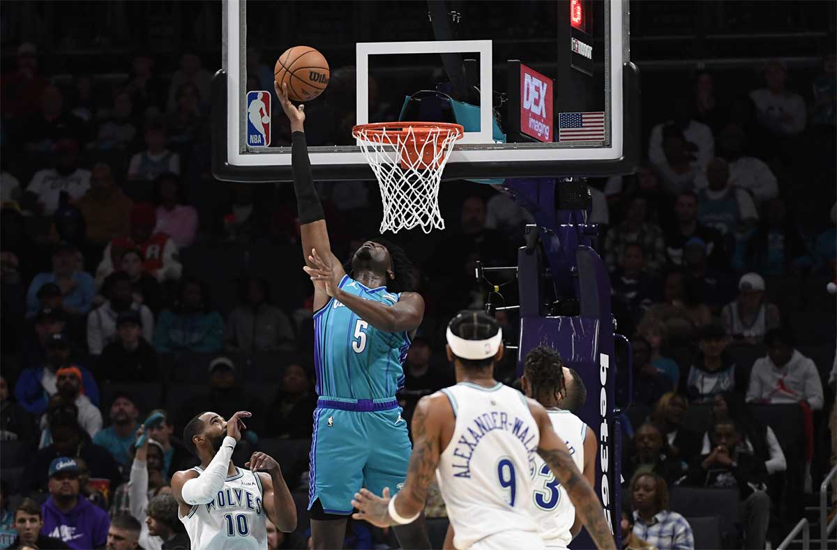 Charlotte Hornets center Mark Williams (5) does a reverse lay-up past Minnesota Timberwolves guard Mike Conley (10) during the first half at the Spectrum Center. 