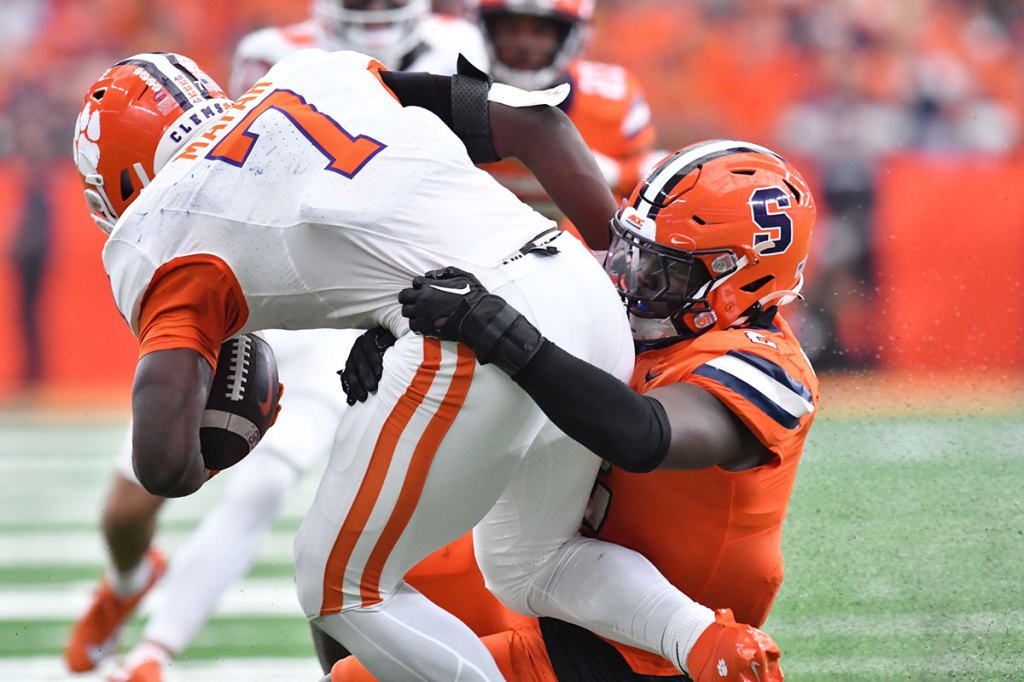 yracuse Orange linebacker Marlowe Wax (2) makes a tackle on Clemson Tigers running back Phil Mafah (7) in the third quarter at the JMA Wireless Dome.