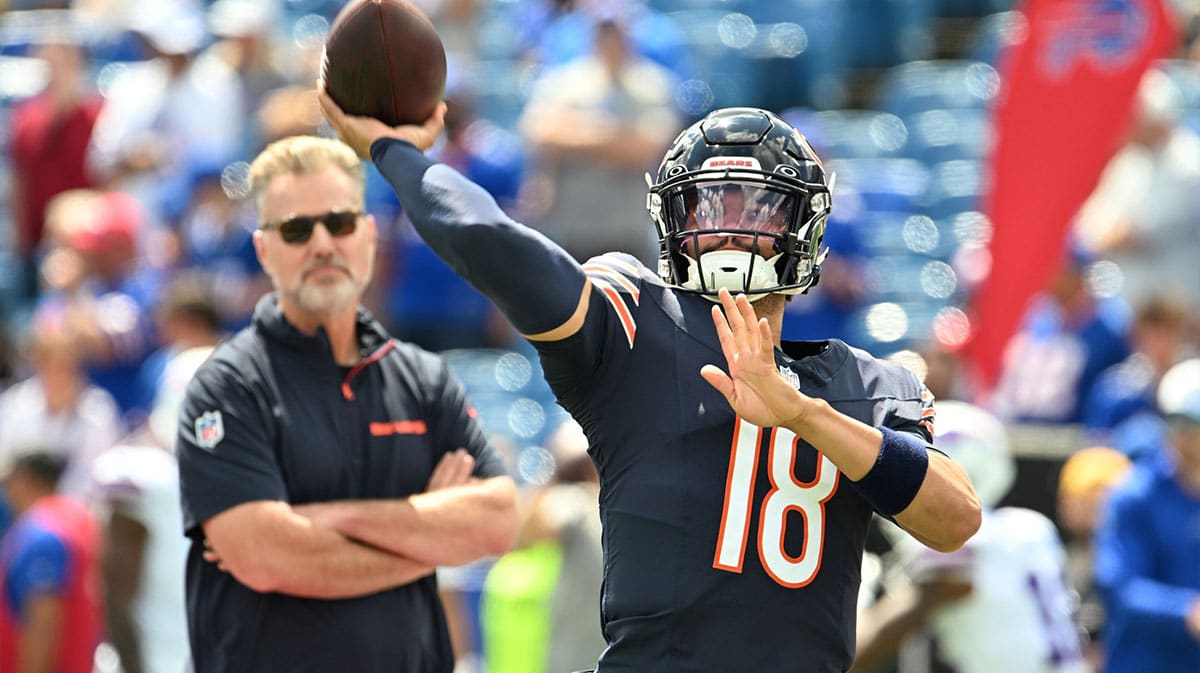 Chicago Bears quarterback Caleb Williams (18) throws a pass in warm ups with head coach Matt Eberflus looking on before a pre-season game against the Buffalo Bills at Highmark Stadium.