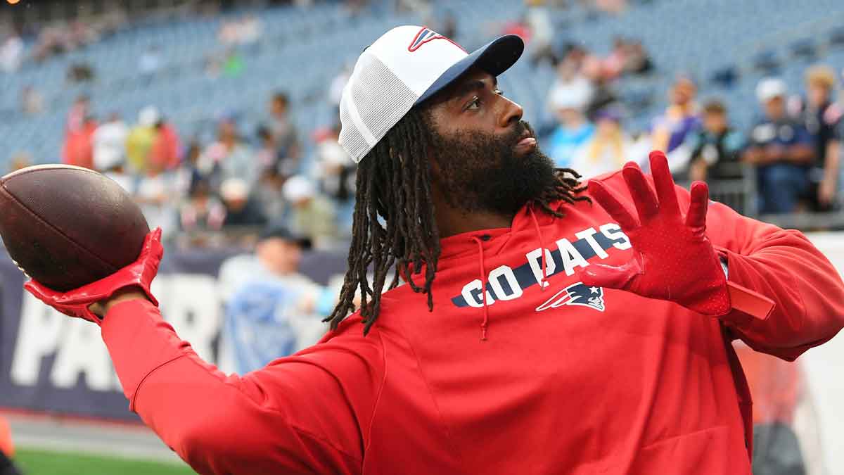 New England Patriots linebacker Matthew Judon (9) plays catch with fans before a game against the Carolina Panthers at Gillette Stadium. 