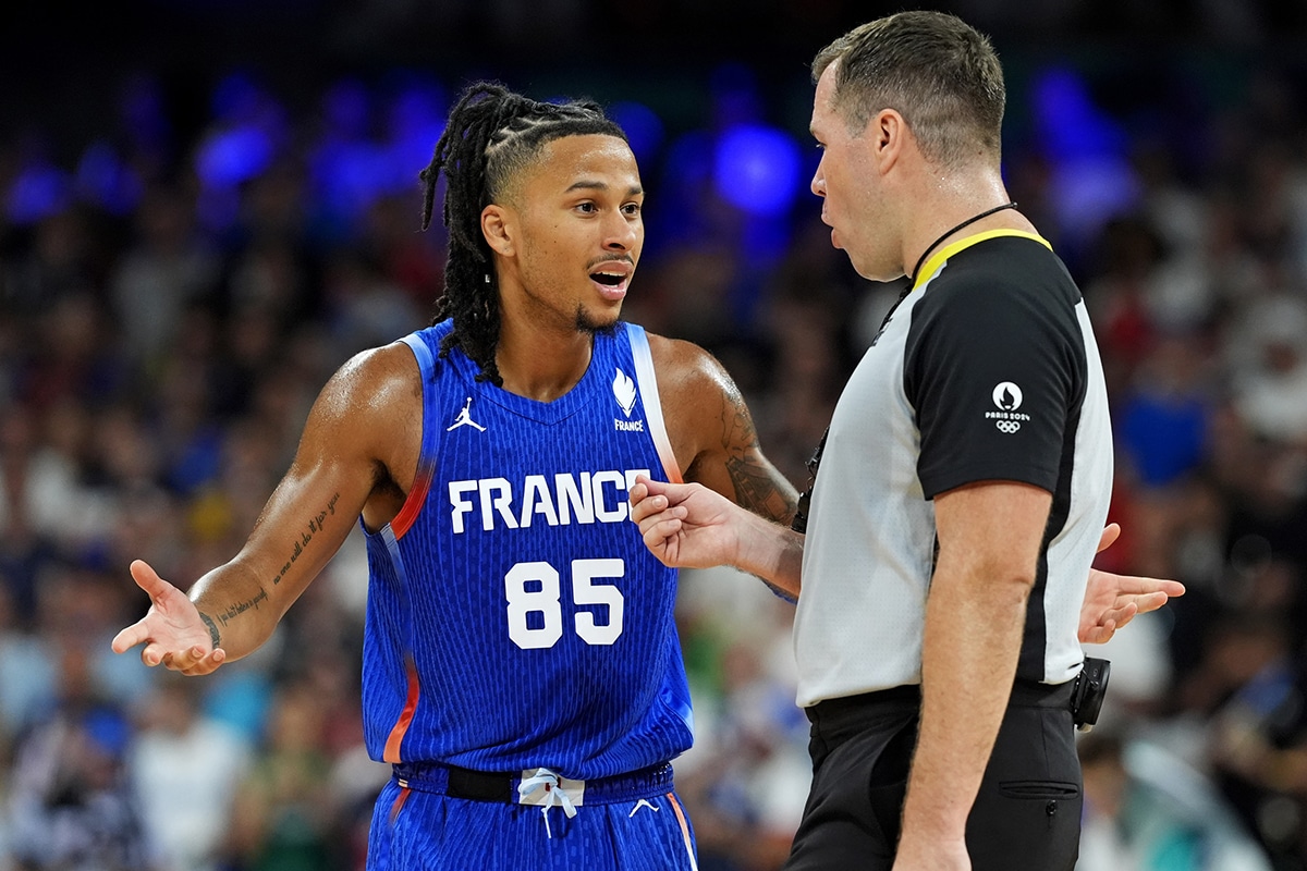 France point guard Matthew Strazel (85) argues a call with a referee during the game against Japan in men’s basketball group B play during the Paris 2024 Olympic Summer Games at Stade Pierre-Mauroy.