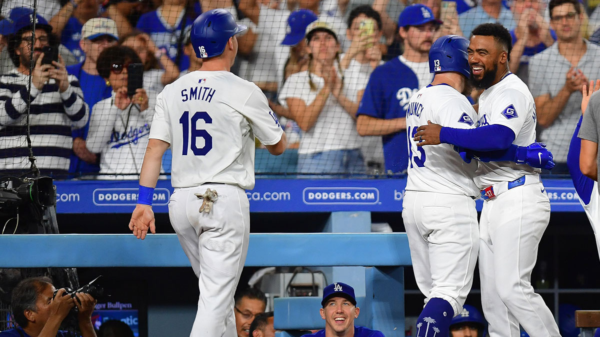 Los Angeles Dodgers third baseman Max Muncy (13) is greeted by left fielder Teoscar Hernandez (37) after hitting a two run home run against the Seattle Mariners during the seventh inning at Dodger Stadium.