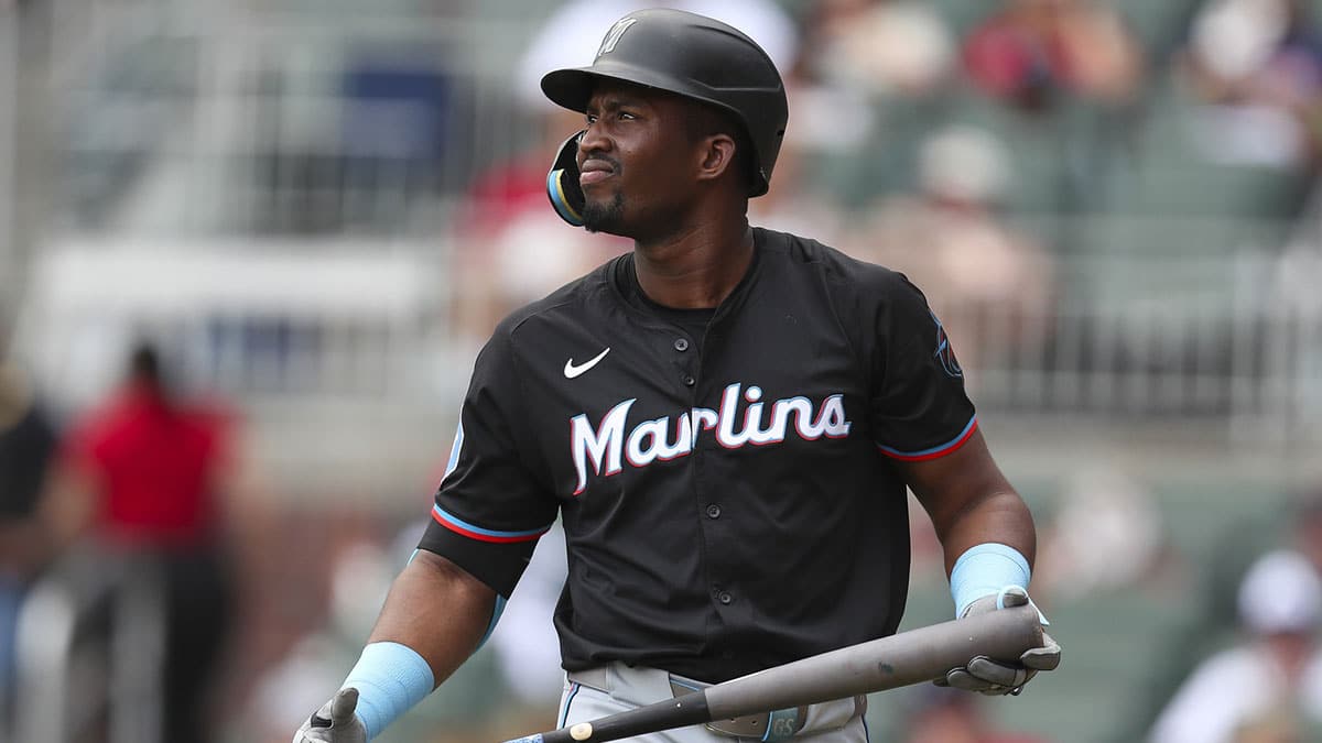 Aug 4, 2024; Cumberland, Georgia, USA; Miami Marlins right fielder Jesus Sanchez (12) reacts to his strikeout in the third inning during the game against the Atlanta Braves at Truist Park. Mandatory Credit: Mady Mertens-USA TODAY Sports