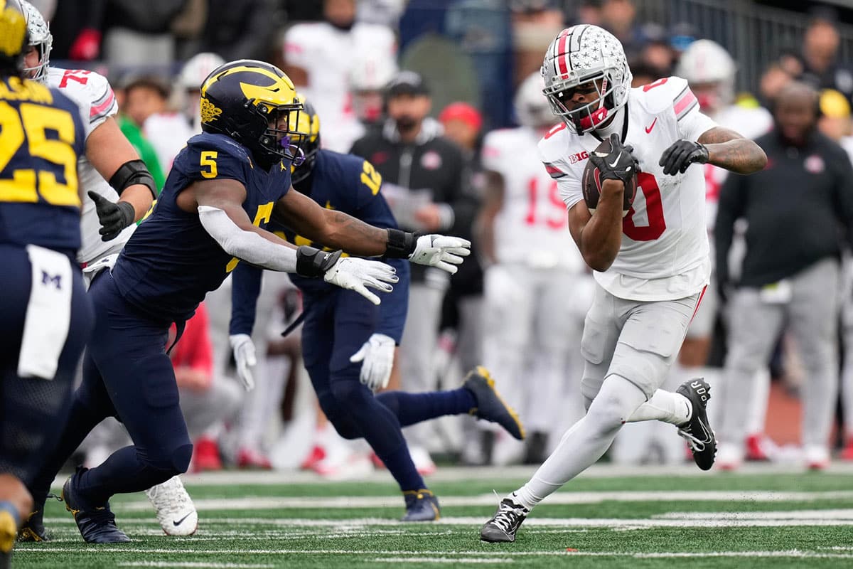 Ohio State Buckeyes wide receiver Xavier Johnson (0) runs past Michigan Wolverines defensive end Josaiah Stewart (5) during the second half of the NCAA football game at Michigan Stadium. Ohio State lost 30-24.