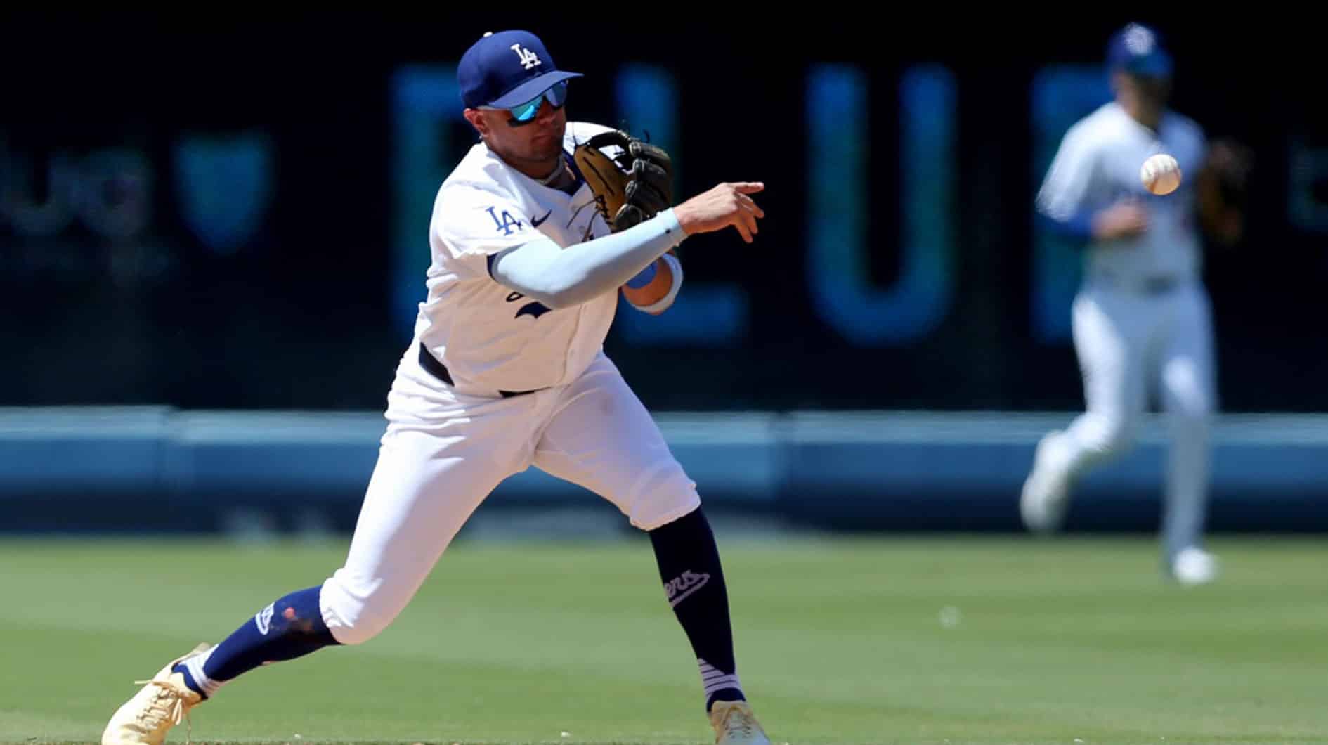 Los Angeles Dodgers shortstop Miguel Rojas (11) starts a double play during the sixth inning against the Milwaukee Brewers at Dodger Stadium.