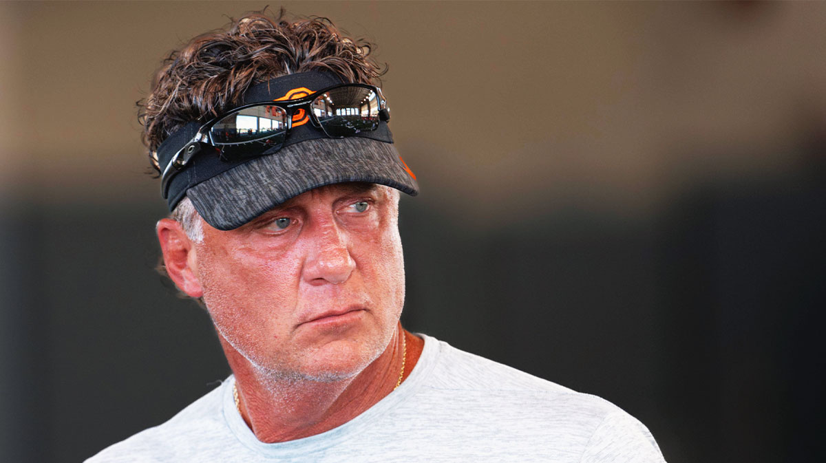 Head coach Mike Gundy walks on the field during an Oklahoma State football practice in Stillwater, Okla.