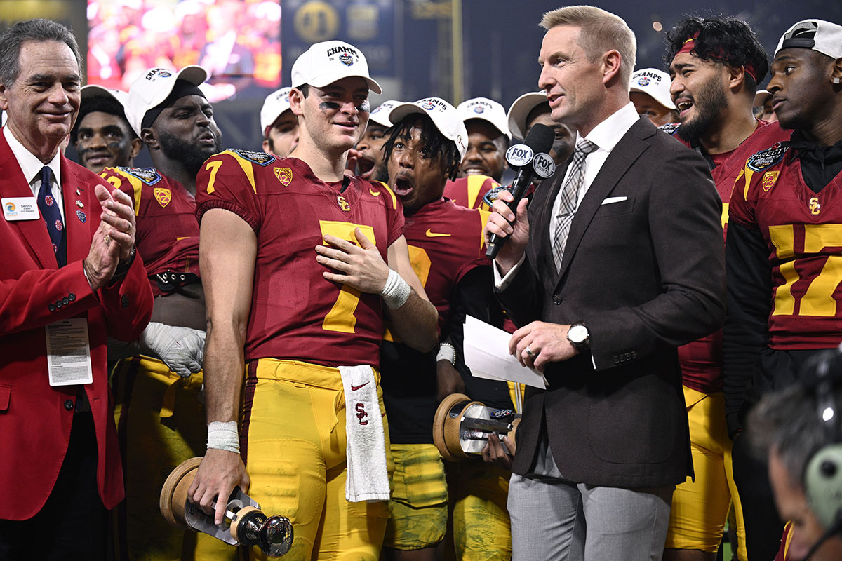 USC Trojans quarterback Miller Moss (7) is presented the offensive MVP trophy after defeating the Louisville Cardinals at Petco Park.