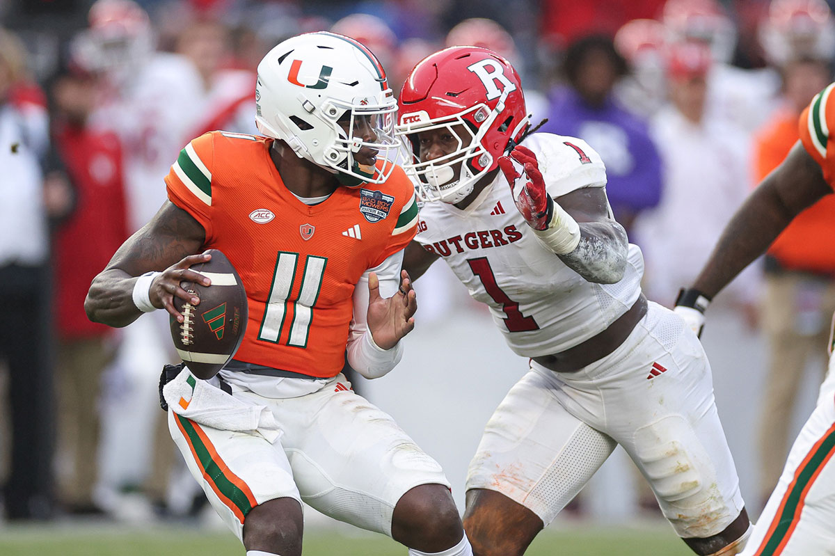 Miami Hurricanes quarterback Jacurri Brown (11) is sacked by Rutgers Scarlet Knights linebacker Mohamed Toure (1) during the first half of the 2023 Pinstripe Bowl at Yankee Stadium.