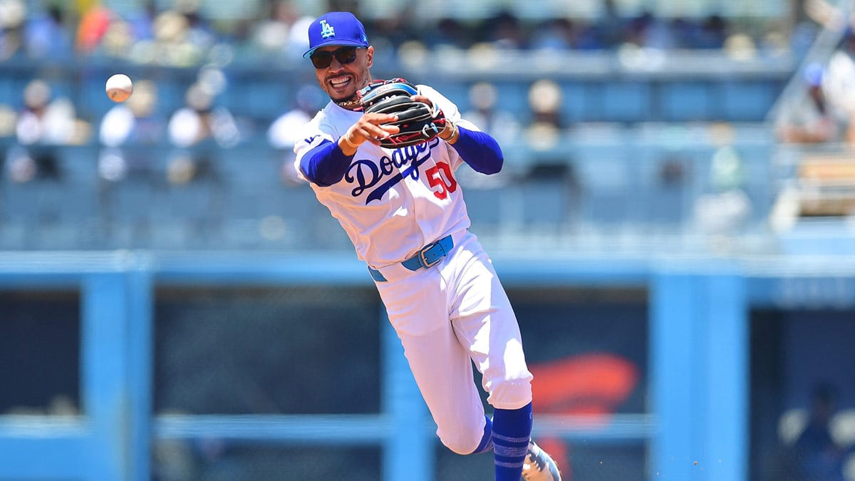 Los Angeles Dodgers shortstop Mookie Betts (50) throws to first for the out against Kansas City Royals catcher Freddy Fermin (34) during the second inning at Dodger Stadium.