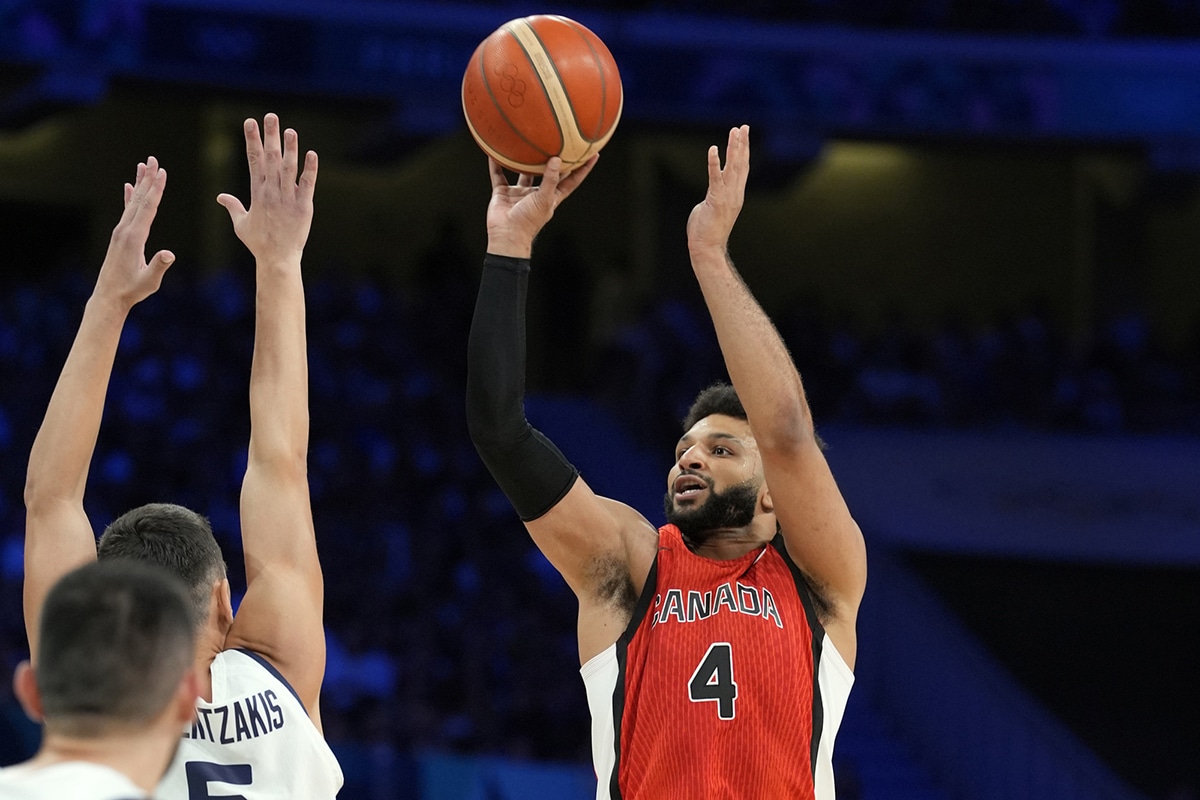 Canada guard Jamal Murray (4) shoots against Greece guard Giannoulis Larentzakis (5) in the first half during the Paris 2024 Olympic Summer Games at Stade Pierre-Mauroy. 