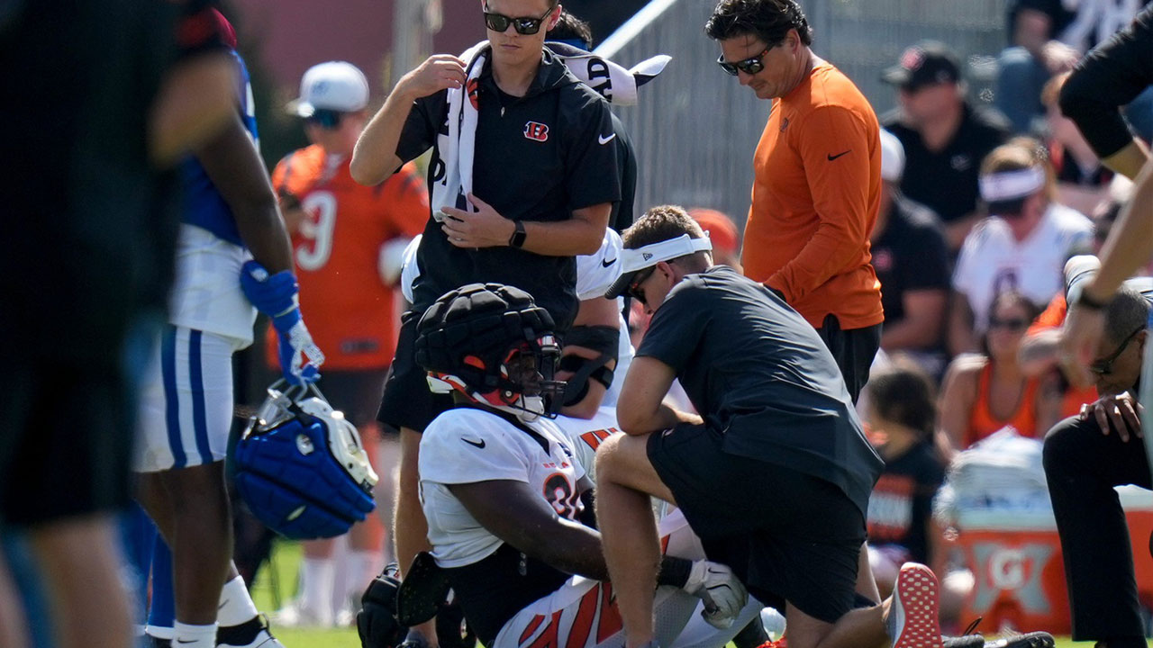 Cincinnati Bengals defensive end Myles Murphy (99) is assisted by the training staff after going down with an injury during a preseason joint practice at the Paycor Stadium practice facility in downtown Cincinnati on Tuesday, Aug. 20, 2024.