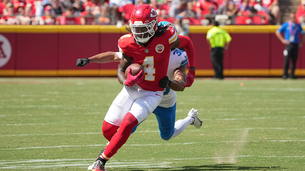 Kansas City Chiefs wide receiver Rashee Rice (4) runs the ball as Detroit Lions cornerback Khalil Dorsey (30) chases during the first half at GEHA Field at Arrowhead Stadium.