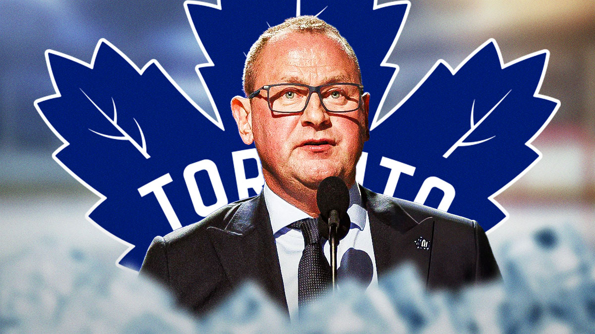 Toronto Maple Leaf GM Brad Treliving next to the Maple Leaf logo